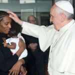 pope lays hands on meriam as she holds child